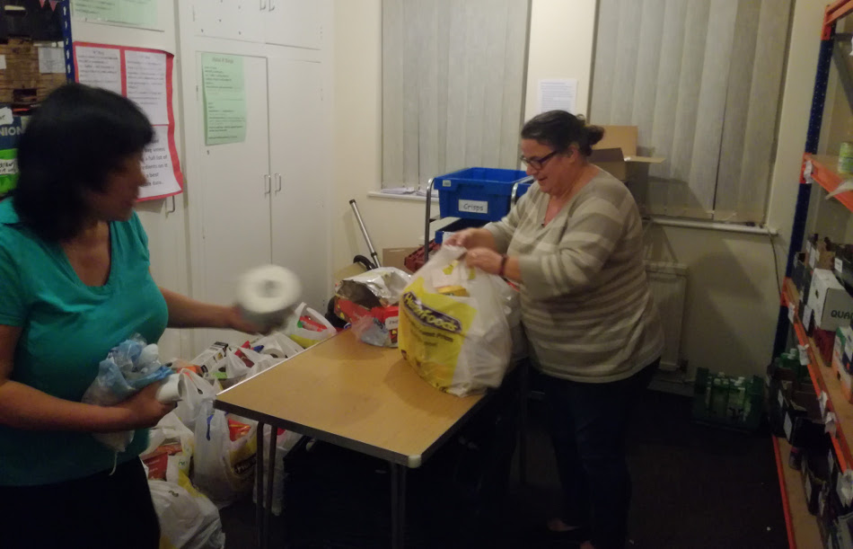<p>Packing food parcels for clients.</p>